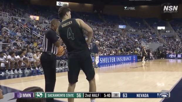 Players try to avoid bats flying around a basketball court